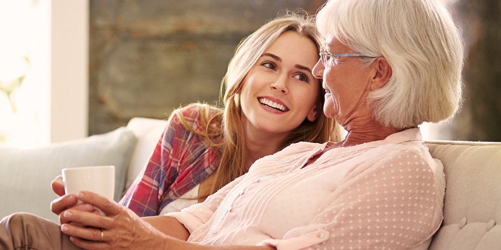 Younger woman and older woman enjoying tea Younger woman and older woman enjoying tea